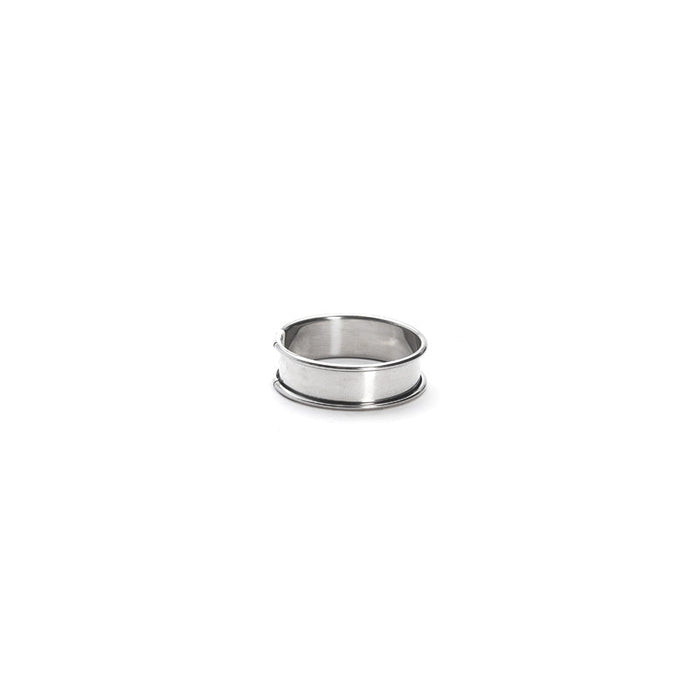 A stainless steel tart ring with a smooth surface and rounded edges, approximately 6 cm in diameter, on a white background.