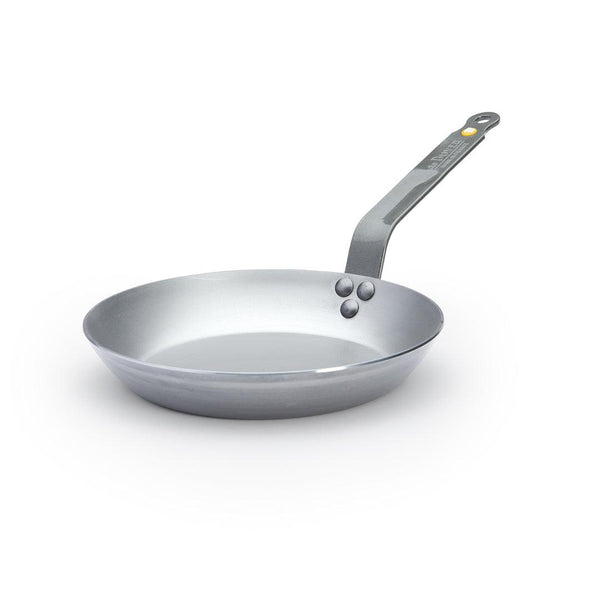 A De Buyer Mineral B carbon steel frying pan with a natural non-stick finish and a steel riveted handle.