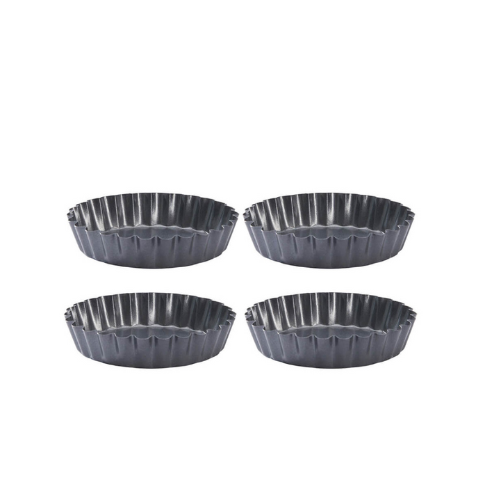 Four De Buyer non stick tartlet showing fluted edges on a white background