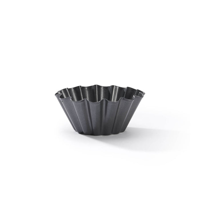 A dark gray fluted tart or muffin tin with a scalloped rim, shown on a clean white background with a soft shadow.