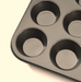 A close-up of the De Buyer non-stick muffin tray, shown at an angle on a white background.
