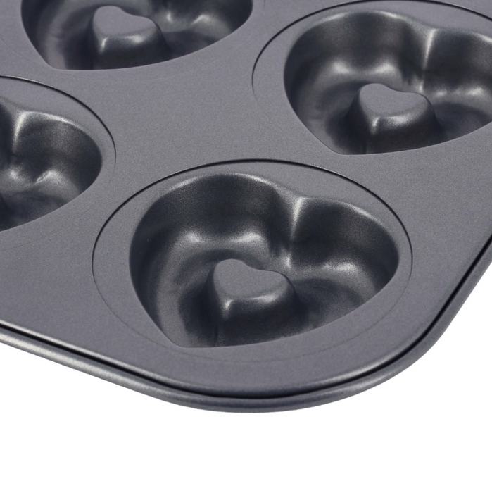 De Buyer non-stick steel cake tray with six heart-shaped moulds, on a white background