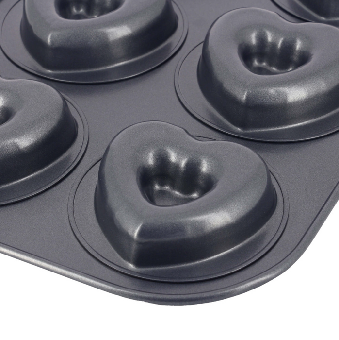 De Buyer six-cup non-stick steel cake tray, close up of one of the heart shaped moulds on a white background