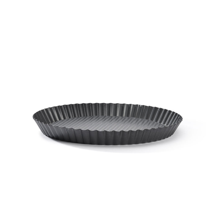 A dark gray fluted tart pan shown from a side angle on a clean white background.