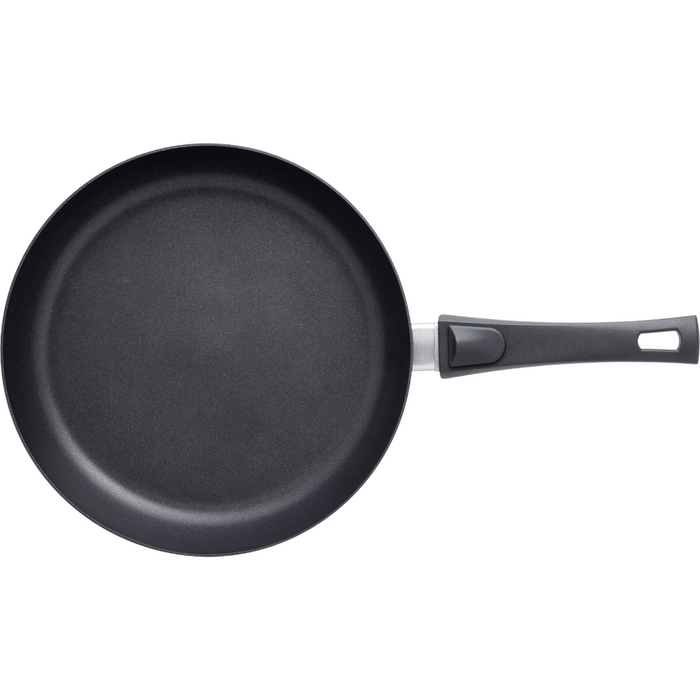 A black SCANPAN Urban 28cm Frying Pan with a smart detachable handle, suitable for modern kitchens.