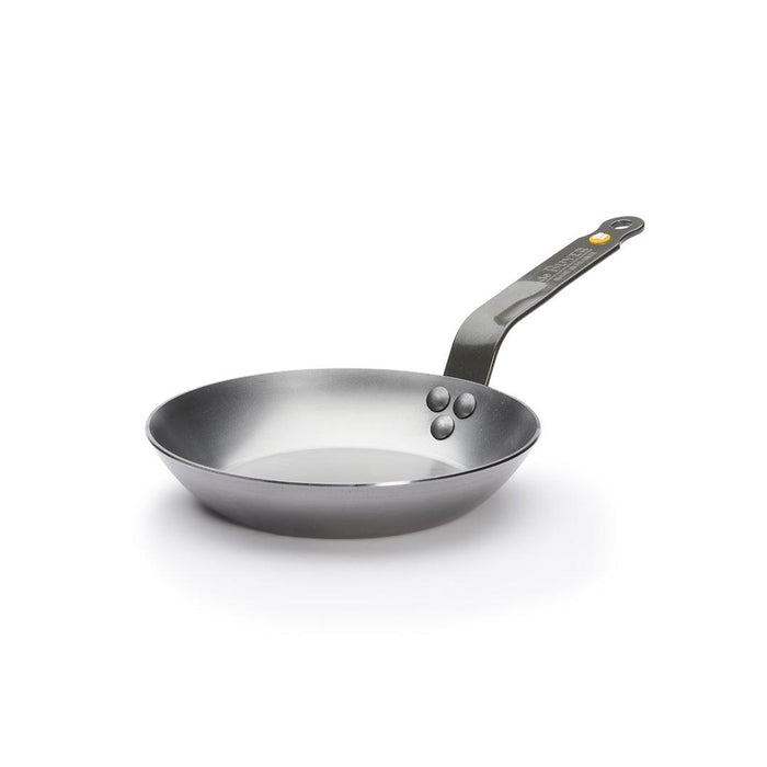 A De Buyer Mineral B carbon steel frying pan with a dark beeswax finish and a Dark Grey handle with a yellow logo.