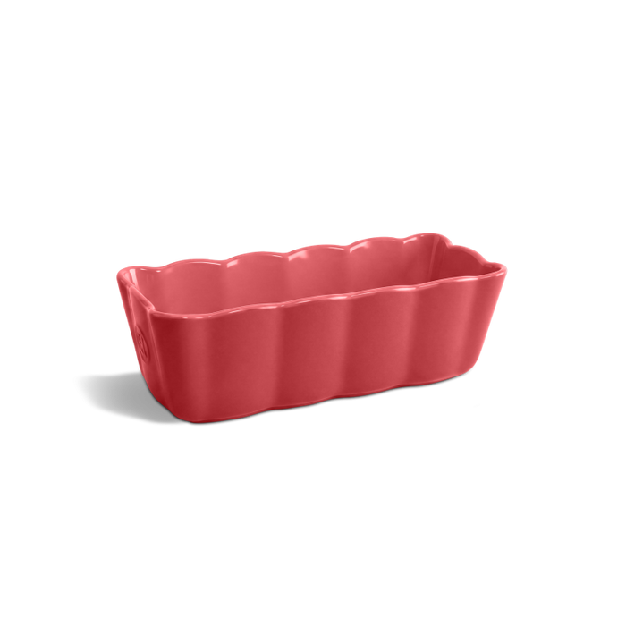 A rectangular scalloped ceramic baking pan in a glossy coral pink color, shown on a clean white background with a soft shadow.