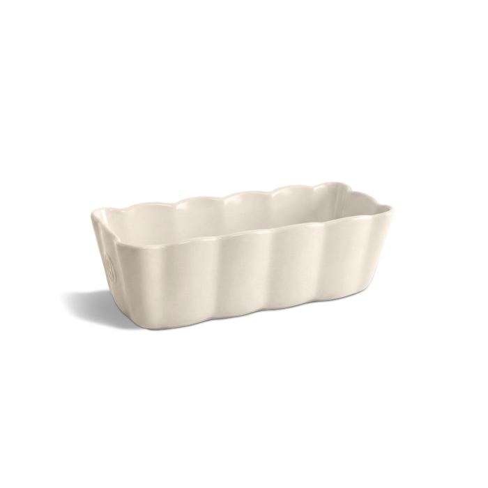 A rectangular ceramic baking pan with a scalloped fluted rim, shown on a clean white background with a soft shadow.