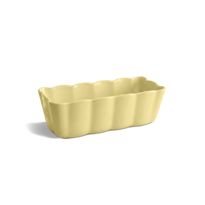 A pale yellow fluted rectangular ceramic baking pan with scalloped edges, shown on a clean white background with a soft shadow.