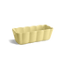 A pale yellow fluted rectangular ceramic baking pan with scalloped edges, shown on a clean white background with a soft shadow.